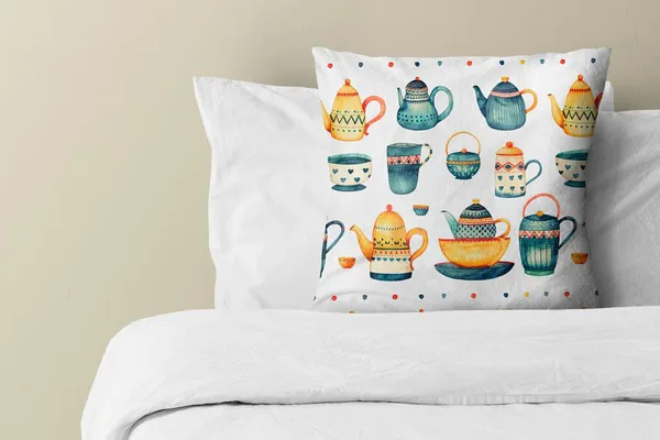 Whimsical Tea Set throw pillow on a bed