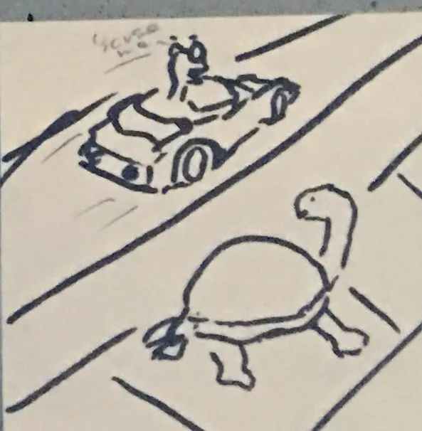 Sticky-note sketch: the worm drives a race car past the turtle